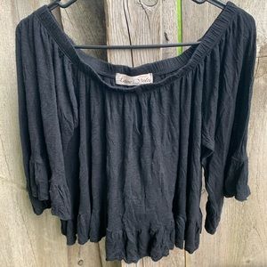 Black flowy off the shoulder blouse.